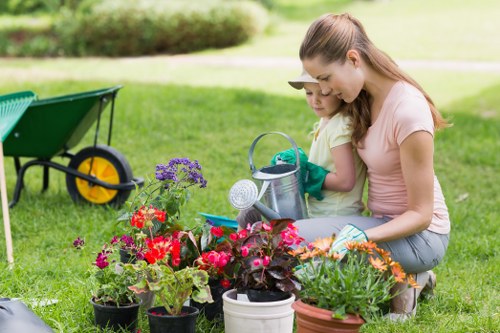 Gardener offering a free quote while pointing at a backyard area to be cleared