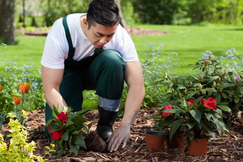 Gardeners at work wearing protective equipment and high-visibility clothing